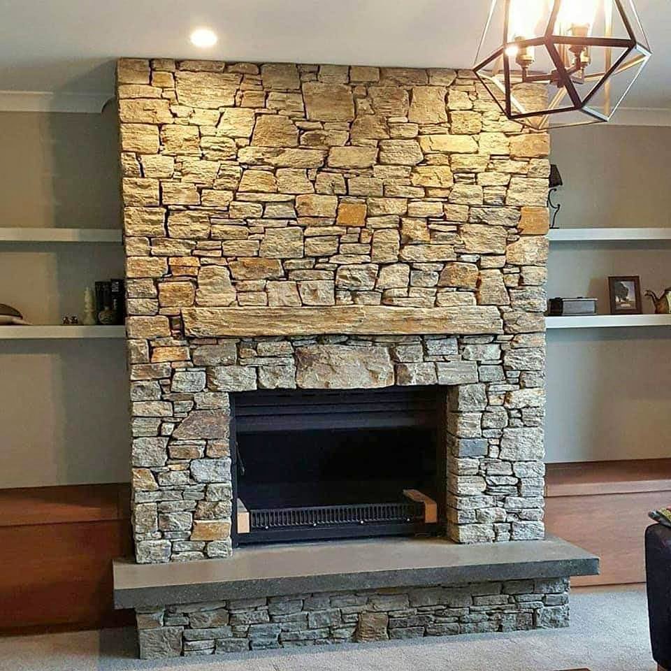 Schist fireplace with timber mantel