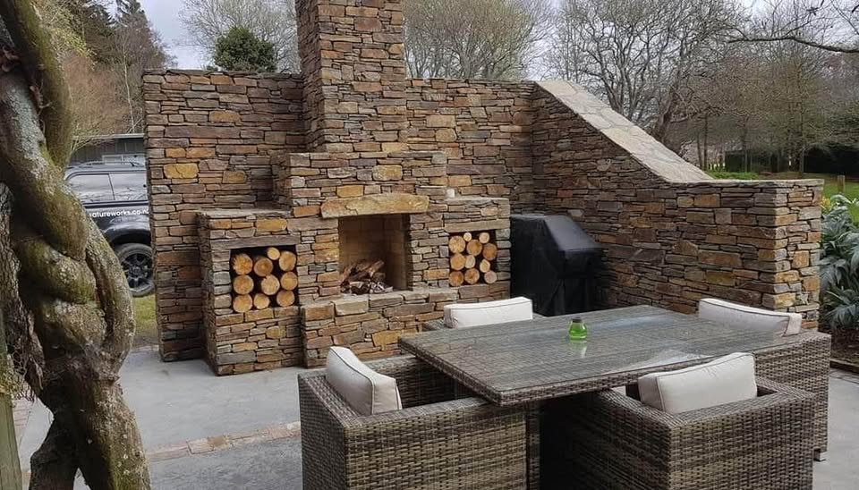 Outdoor kitchen with stone firewood bays