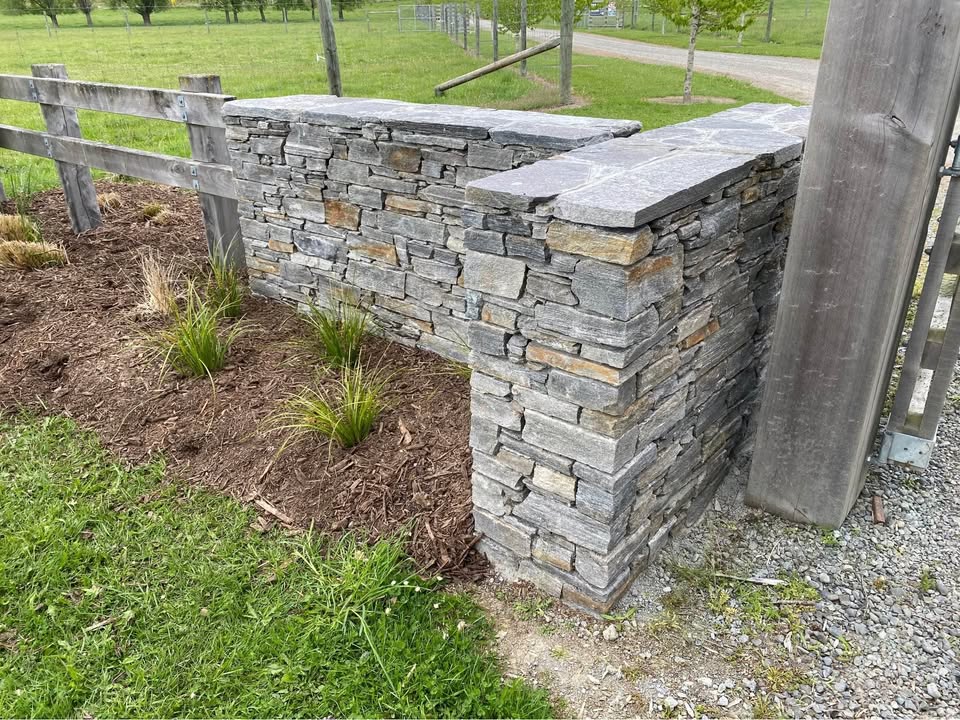 A finished schist wall with capping stones