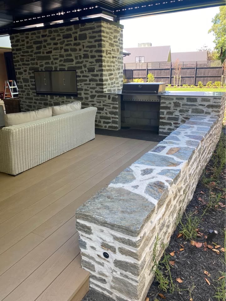 Outdoor living area with stone bar and bench
